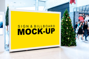Mock up horizontal billboard near christmas tree in shopping mall