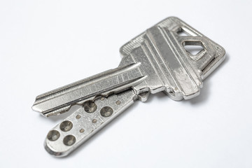 Close up of Silver key on white background