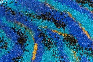 Layered colorful sand pattern. Marble style background. Blue and gold powder texture.