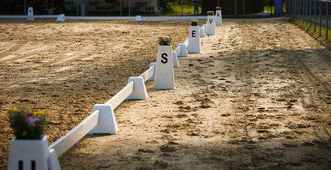 Dressage rectangle Closeup of the limit letters, on a riding field..