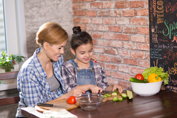 Mom and daughter cook together at home