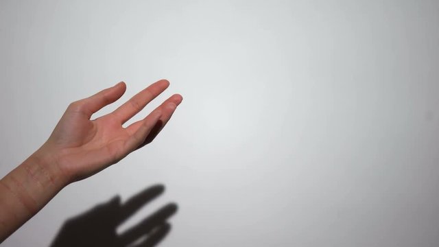 Hand with scares shaking on white background, self-infliction, self-punishment