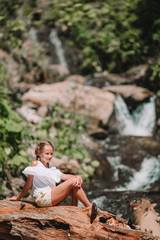 Little girl enjoying view of waterfall in Krasnay Poliana