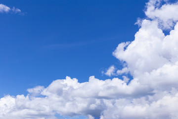 Blue sky background with white clouds, rain clouds on sunny summer or spring day.