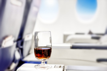 Airplane business glass drink in beautiful style of passenger plane first class cabin with luxury...