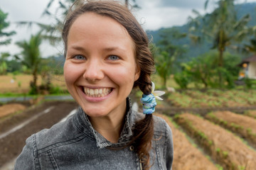 Woman smiling with perfect smile and white teeth in a park and looking at camera