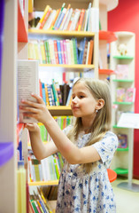  girl   between shelves in library.