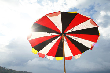 Fototapeta premium Beach umbrella on sky background
