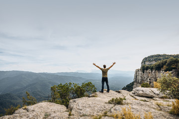 Man showing freedom in the mountain