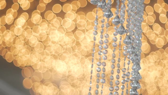 Crystal strass lamp over warm light background luxury interior design