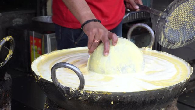 Street trade food : cooking chiape rayta on the street market in city Udaipur, Rajasthan, India. Indian chef making street food. Close up