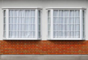 modern glass window with brick block on cement facade wall background.