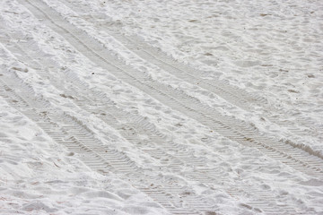 tractor Wheel track on pure white sand beach.