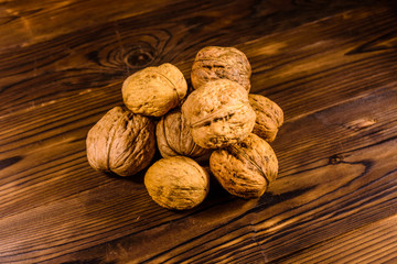 Pile of walnuts on a wooden table