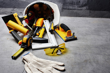set of construction tools on a black wall background