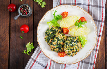 Baked steak chopped chicken fillet with spinach and a side dish of mashed potatoes. European cuisine. Dietary food. Top view