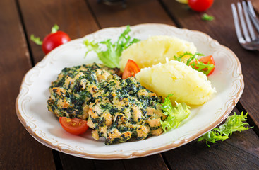 Baked steak chopped chicken fillet with spinach and a side dish of mashed potatoes. European cuisine. Dietary food.