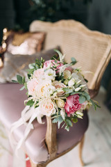 Wedding bouquet of the bride in a bright Studio. Decor in the style of fine art.