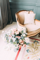 Wedding bouquet of the bride in a bright Studio. Decor in the style of fine art.
