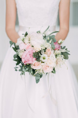 Wedding bouquet of the bride in a bright Studio. Decor in the style of fine art.