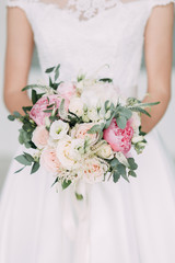 Wedding bouquet of the bride in a bright Studio. Decor in the style of fine art.