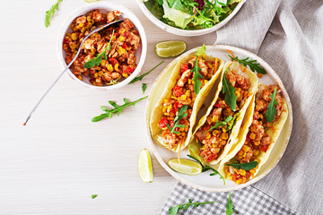 Mexican tacos with chicken meat, corn and tomato sauce. Latin American cuisine. Taco, tortilla,...