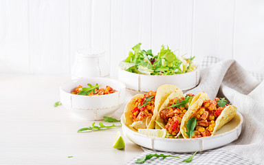 Mexican tacos with chicken meat, corn and tomato sauce. Latin American cuisine. Taco, tortilla,...