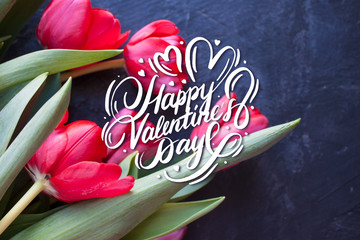 Valentines Day card with Happy Valentine's Day calligraphy text and red tulips on background. 14...