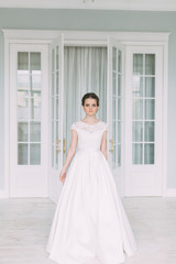 The bride in the white Studio with a bouquet. Wedding in the European style fine art.