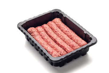 Packed raw sausages in black plastic black tray