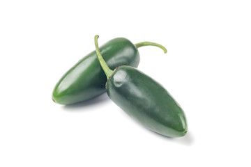 Two green chilies (jalapeno) on white background