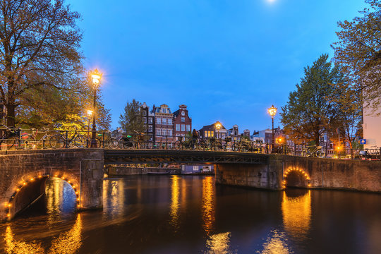Amsterdam Netherlands, night city skyline Dutch house at canal waterfront