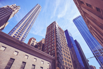 Fototapeta na wymiar Looking up at Manhattan skyscrapers, color toned picture, USA.