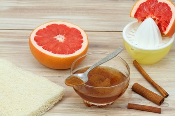 Cellulite treatment from honey, cinnamon and grapefruit juice.  Ingredients for homemade anti cellulite wrap on the table