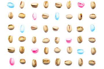Many colors Inshell pistachios and cracked pistachios on white background, Top view. Pistachio nuts pattern