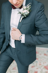 Stylish young groom in a bright Studio. Wedding in the European style fine art.