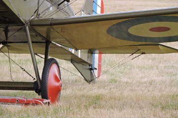 A wheel and a wing of a biplane bomber