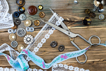 buttons, lace, tape and a dressmaker scissors