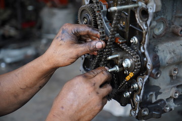 Obraz na płótnie Canvas Hand working on car's engine