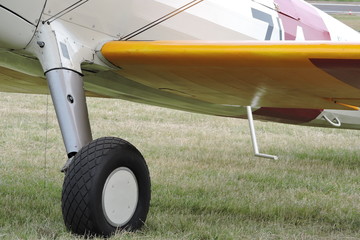A wheel and a wing of a biplane
