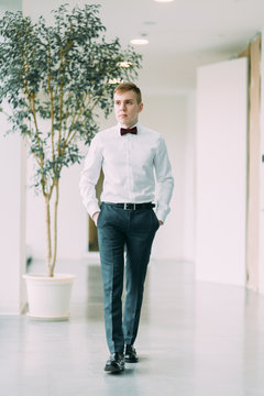 Stylish young groom in a bright Studio. Wedding in the European style fine art.
