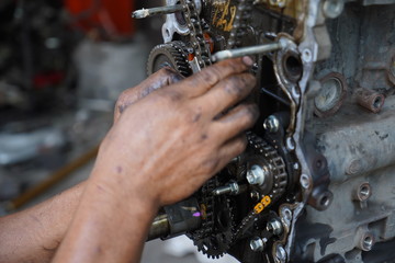 Obraz na płótnie Canvas Hand working on car's engine