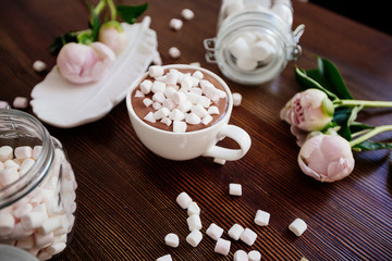 Cocoa with marshmallow and flowers.