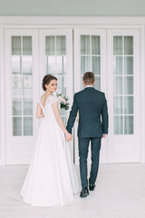 Fototapeta premium Beautiful couple in the Studio standing and dancing. Wedding in the European style fine art.