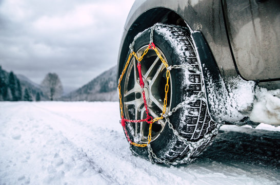 Snow chains on tire at winter road