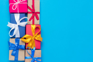 A lot of gift boxes on a blue background. Holiday concept, New Year, Christmas, Birthday, Valentine's Day. Copy space. Flat lay, top view.