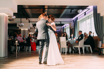 The first dance of a young couple. Wedding traditions in European style.