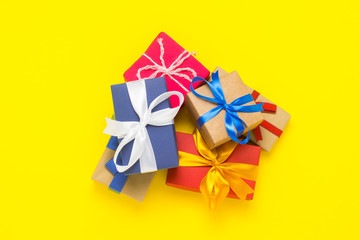 A lot of gift boxes on a yellow background. Holiday concept, New Year, Christmas, Birthday, Valentine's Day. Flat lay, top view.