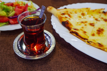 Turkish tea in traditional glass and starter on the table