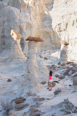 A hiker among hoodoos sandstone formations in Utah, USA 